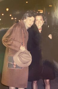 Grandmother next to granddaughter at night in a street in London