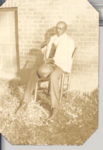 “Man Sitting Pumping Up a Ball” (1925)
